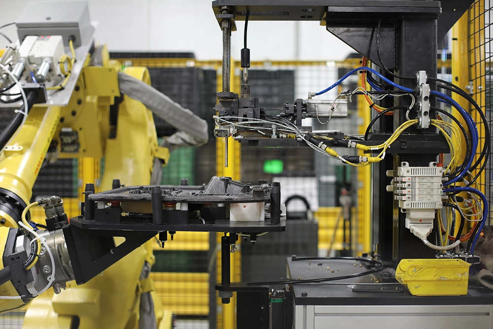 Industrial robotic equipment handling a molded part